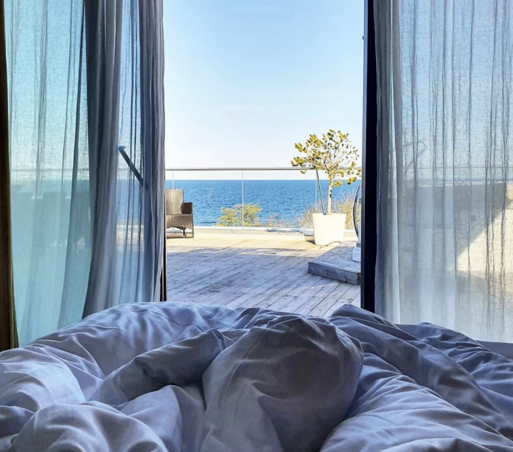 A picture in bed with an open view of the ocean at Hotel Novi in Gotland