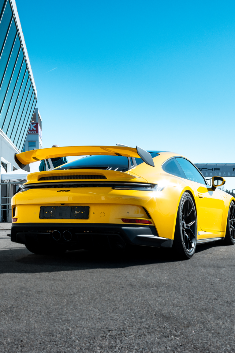 A picture of a yellow Porsche GT3 taken at a Mantorp Park Trackday event hosted by Drivers Club